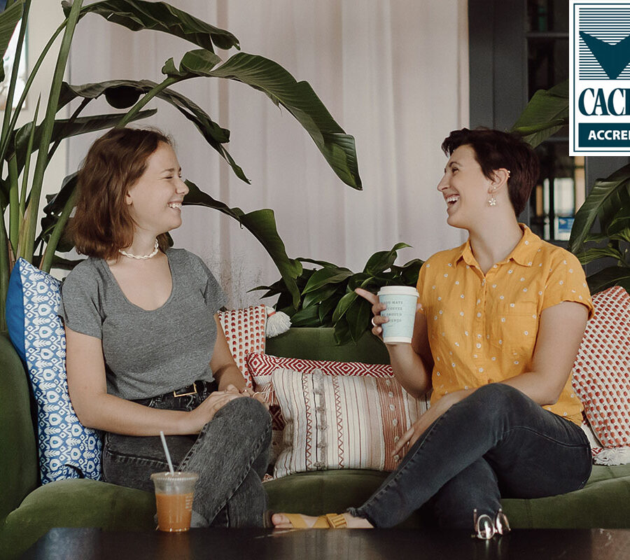 Two PBA students talk in a coffee shop.